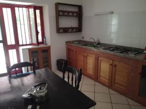 a kitchen with a table and a sink and a stove at Fosso Marchese in Cusano Mutri