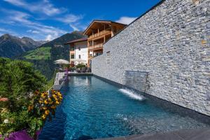 a swimming pool in the side of a building at Mountain Village Hasenegg in Schenna