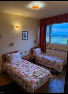 a hotel room with two beds and a window at Guest House Bed and Birding in Durankulak
