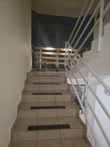 a stairway with wooden steps and a window at SMB home PANORAMA in Oradea