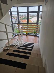 a staircase in a building with a large window at SMB home PANORAMA in Oradea