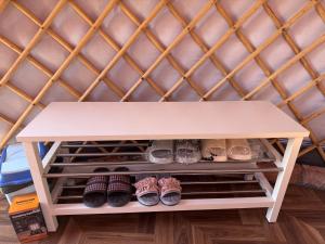 a shelf in a room filled with shoes at Mongolian traditional house Ger in Dzuunmod