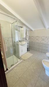 a bathroom with a glass shower and a sink at Linoq in Montepagano