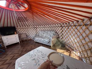a person is holding a mirror in a yurt at Mongolian traditional house Ger in Dzuunmod