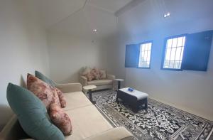 a living room with a couch and a table at شاليه الكوثر in Al Baha