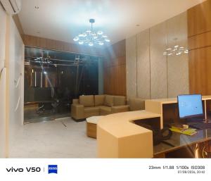 a room with a couch and a desk with a computer at SW Hotel MG Road in Bangalore