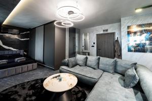 a living room with a couch and a table at Beni Deluxe 2 in Plovdiv