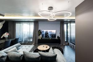 a living room with a couch and a ceiling fan at Beni Deluxe 2 in Plovdiv +28 photos