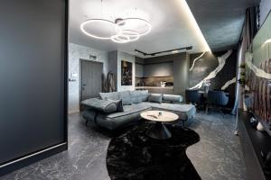 a living room with a couch and a table at Beni Deluxe 2 in Plovdiv