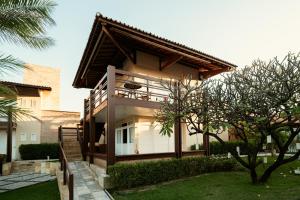 a house with a staircase leading up to it at Pousada Tropical Ilhas in Aquiraz