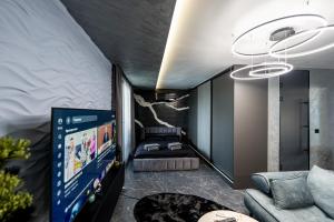 a living room with a couch and a flat screen tv at Beni Deluxe 2 in Plovdiv