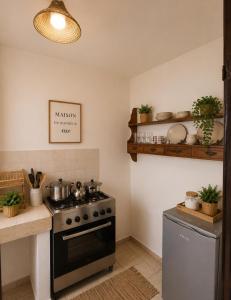 a kitchen with a stove with pots and pans at Raha-26 in Al Ghar