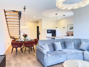 a living room with a blue couch and a table at ELBE6 Apartments in Wittenberge