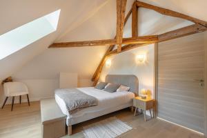 a bedroom with a bed in a attic at Maison Sophie for 10 guests in Pierrefonds