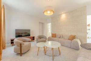 a living room with a couch and a table at Maison Sophie for 10 guests in Pierrefonds