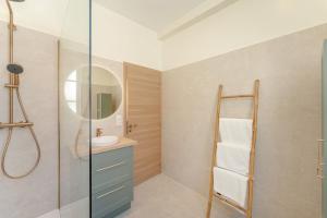 a bathroom with a sink and a mirror at Maison Sophie for 10 guests in Pierrefonds +22 photos