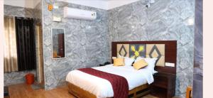 a bedroom with a large bed in a room at Anbu Grand Inn in Chidambaram