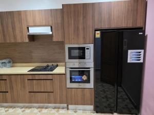a kitchen with a stove and a refrigerator at the urban escape in Kwabenyan