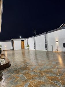 an empty patio at night with a building at the urban escape in Kwabenyan