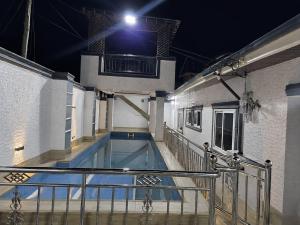 a swimming pool in a building at night at the urban escape in Kwabenyan