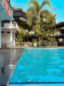 a large blue swimming pool in front of a building at Nuwanma in Halpatota