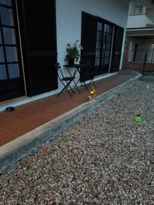 a patio of a house with a table and a chair at Casa Lena in Vagos