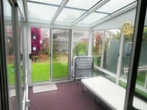 a screened in porch with a table and a chair at STR25-15 Home 3 Bedrooms 2 Bath in Marina