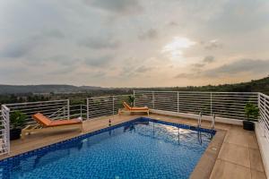 a swimming pool on the roof of a building at Nivaara by GHD Hotels in Nerul