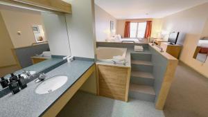 a bathroom with a sink and a mirror at Eldorado, a Coast Hotel in Dawson City +66 photos