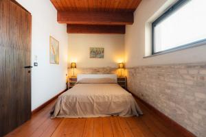 a bedroom with a bed and a brick wall at Residenza Michetti in Francavilla al Mare
