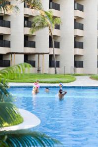 a group of people in the swimming pool at a hotel at Pirâmide Palace Hotel in Natal
