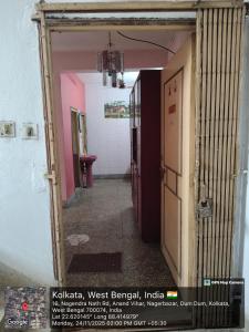 a hallway with a door open to a room at Anand Vihar in kolkata