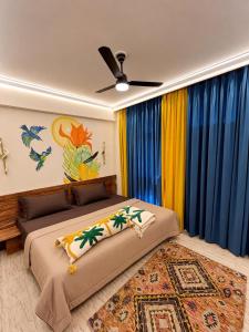 a bedroom with two beds and a ceiling fan at Canvas and Cabana - Cabo in Sonīpat