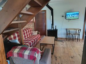 a living room with a couch and a table at Domček u Alberta in Vrbov
