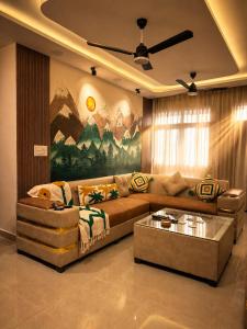 a living room with a couch and a table at Canvas and Cabana - Cabo in Sonīpat