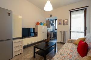 a living room with a couch and a tv at oasi bengasi in Moncalieri