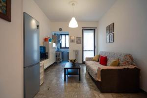 a living room with a couch and a tv at oasi bengasi in Moncalieri +5 photos