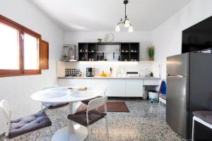 a kitchen with a white table and a refrigerator at Casa Arico Viejo in Arico Viejo