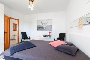 a bedroom with a large bed with two chairs at Casa Arico Viejo in Arico Viejo