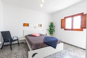 a bedroom with a bed and a chair in it at Casa Arico Viejo in Arico Viejo