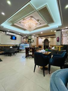 a restaurant with tables and chairs and a chandelier at المهاجر فرع قريش in Jeddah