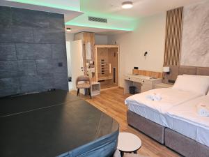 a bedroom with a bed and a desk in a room at Zasavski Gurman in Dol pri Hrastniku