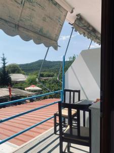 a balcony with a table and chairs on a deck at Olive Nest Bunec in Sasaj +9 photos