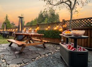 a patio with a picnic table and a grill at Coast Parksville Hotel in Parksville