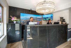 a man and woman sitting at a counter with a laptop at Coast Parksville Hotel in Parksville +49 photos