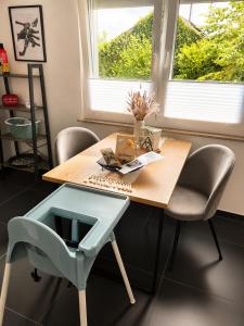 a wooden table with a chair and a desk at Ferienwohnung Elya Gartenparadies nahe Events, Outlet und Spa in Bad Münstereifel +12 photos