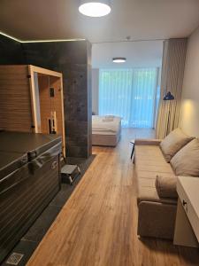 a living room with a couch and a bedroom at Zasavski Gurman in Dol pri Hrastniku