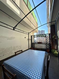 a room with a checkered bed on a balcony at 120 mq trilocale e terrazzo in Moncalieri