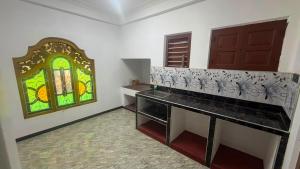 a room with a counter and a stained glass window at SN Villa in Jaffna