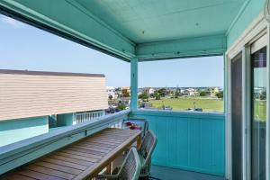 a porch with a bench and a view of a field at Beach Getaway w Pool & Private Balcony in Atlantic Beach